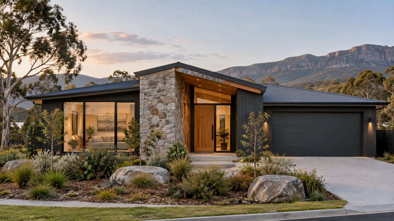 A single-storey home with a stone entry feature, timber door and a rocky mountain range behind